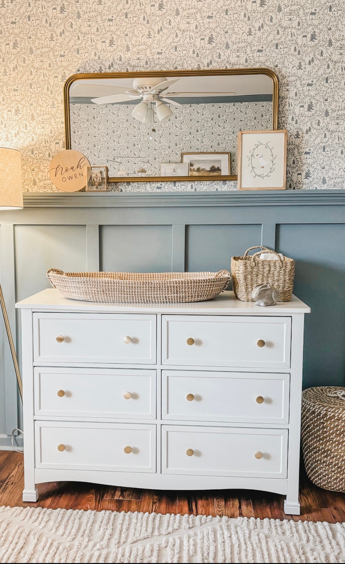 Baby boys nursery with blue wall panelling and Cottages in the Woods Wallpaper