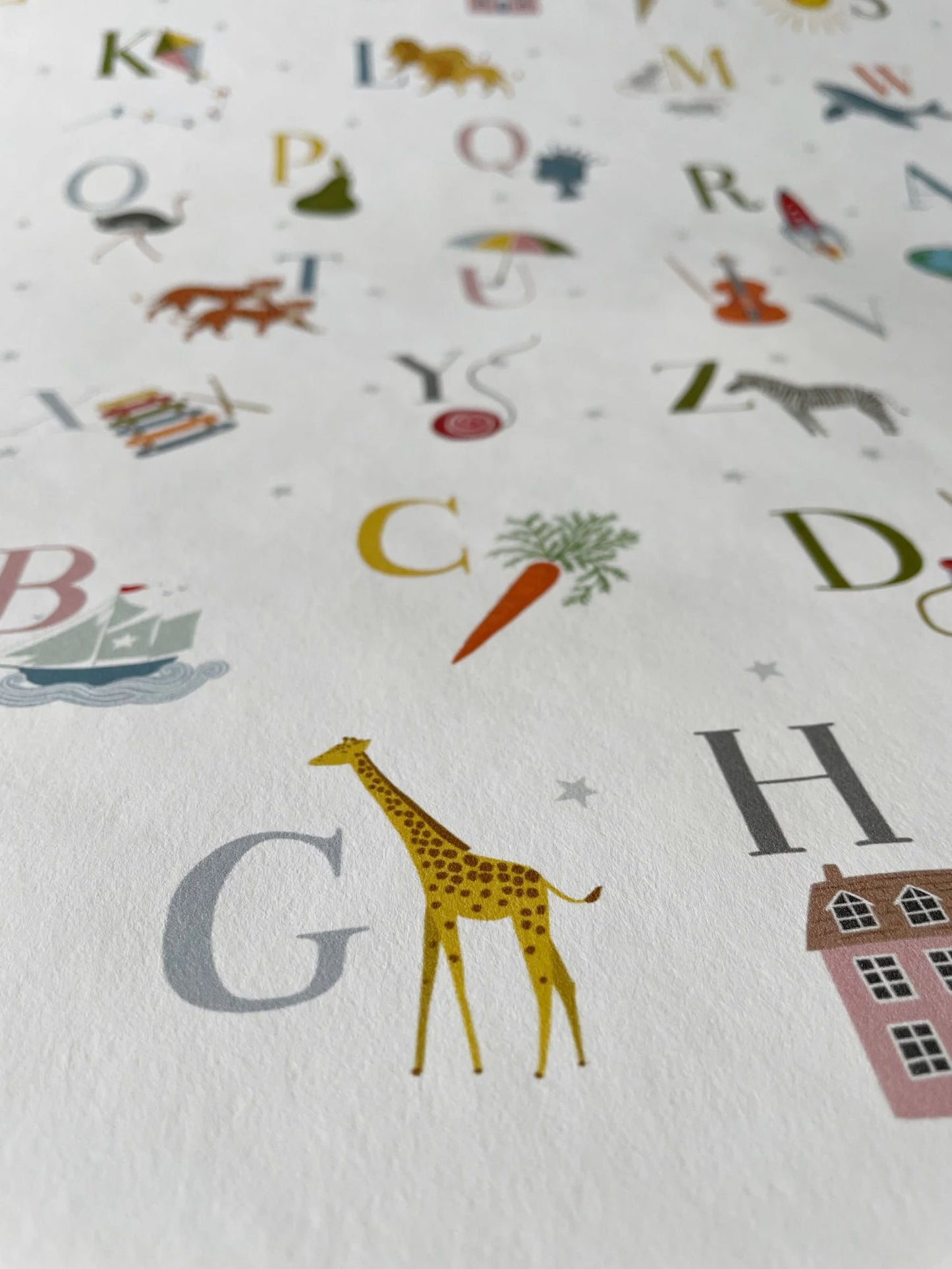 Close up of ABC luxury children's wallpaper with letters of the alphabet and icons for each letter