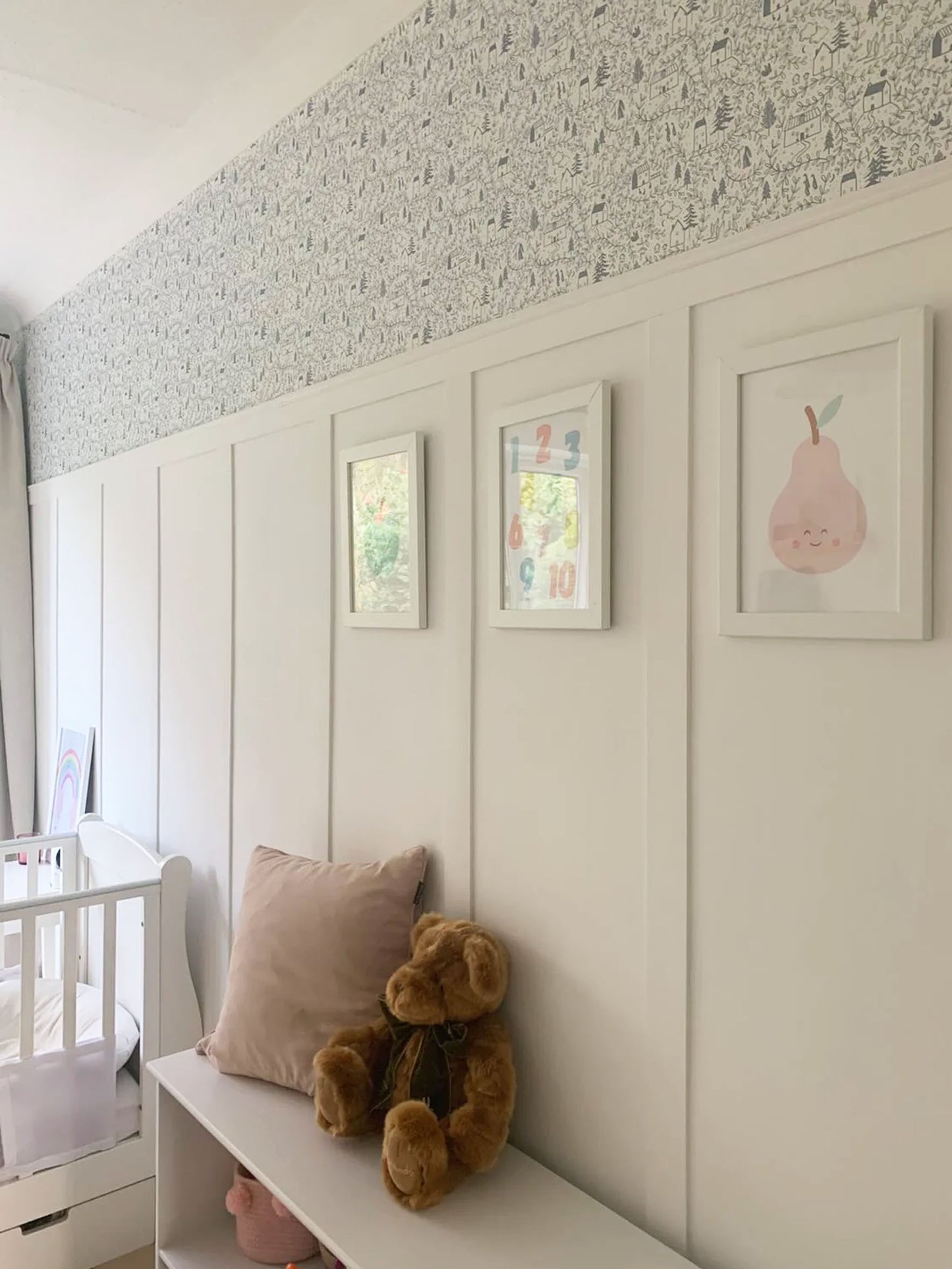 Cottages in the woods luxury children's wallpaper featured in nursery with white wall panelling
