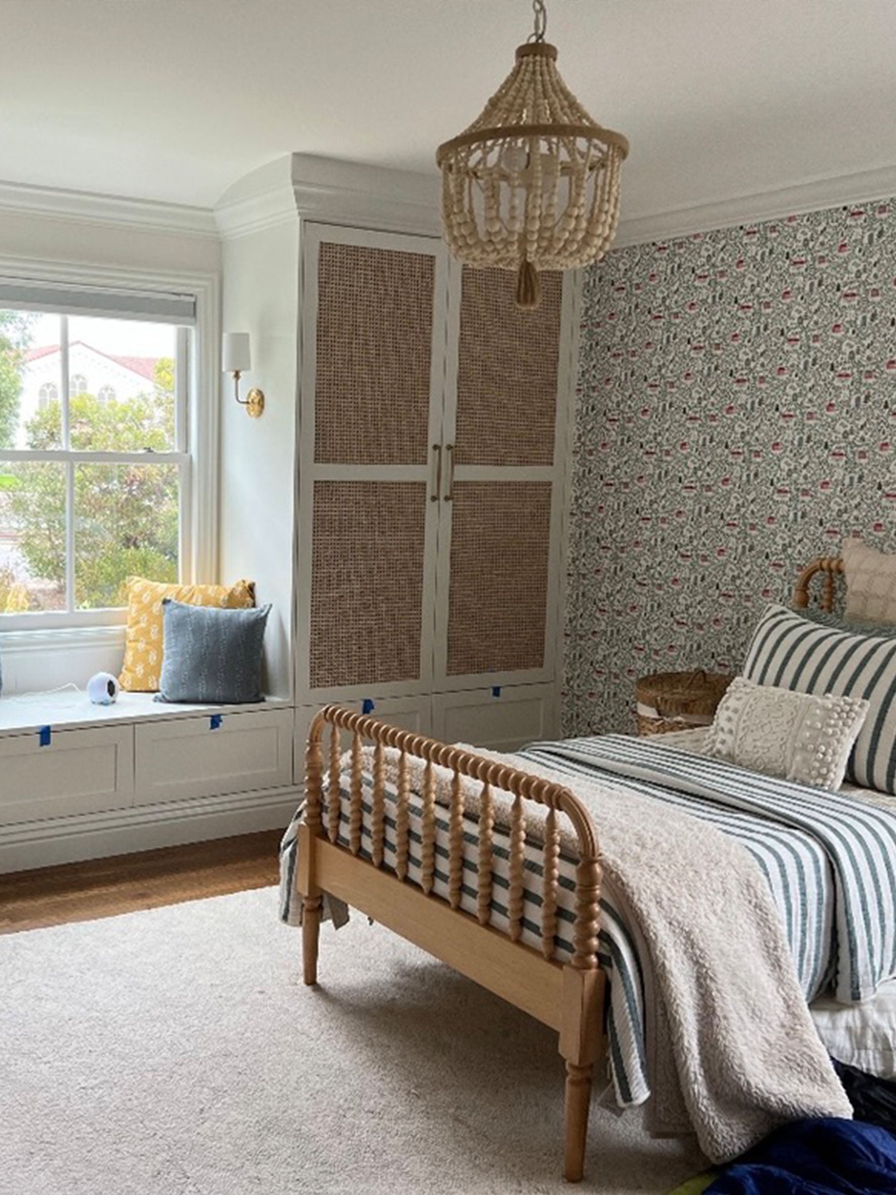 Girls bedroom with English Country Cottages wallpaper, Crate and Barrel kids single bed, built in cupboards