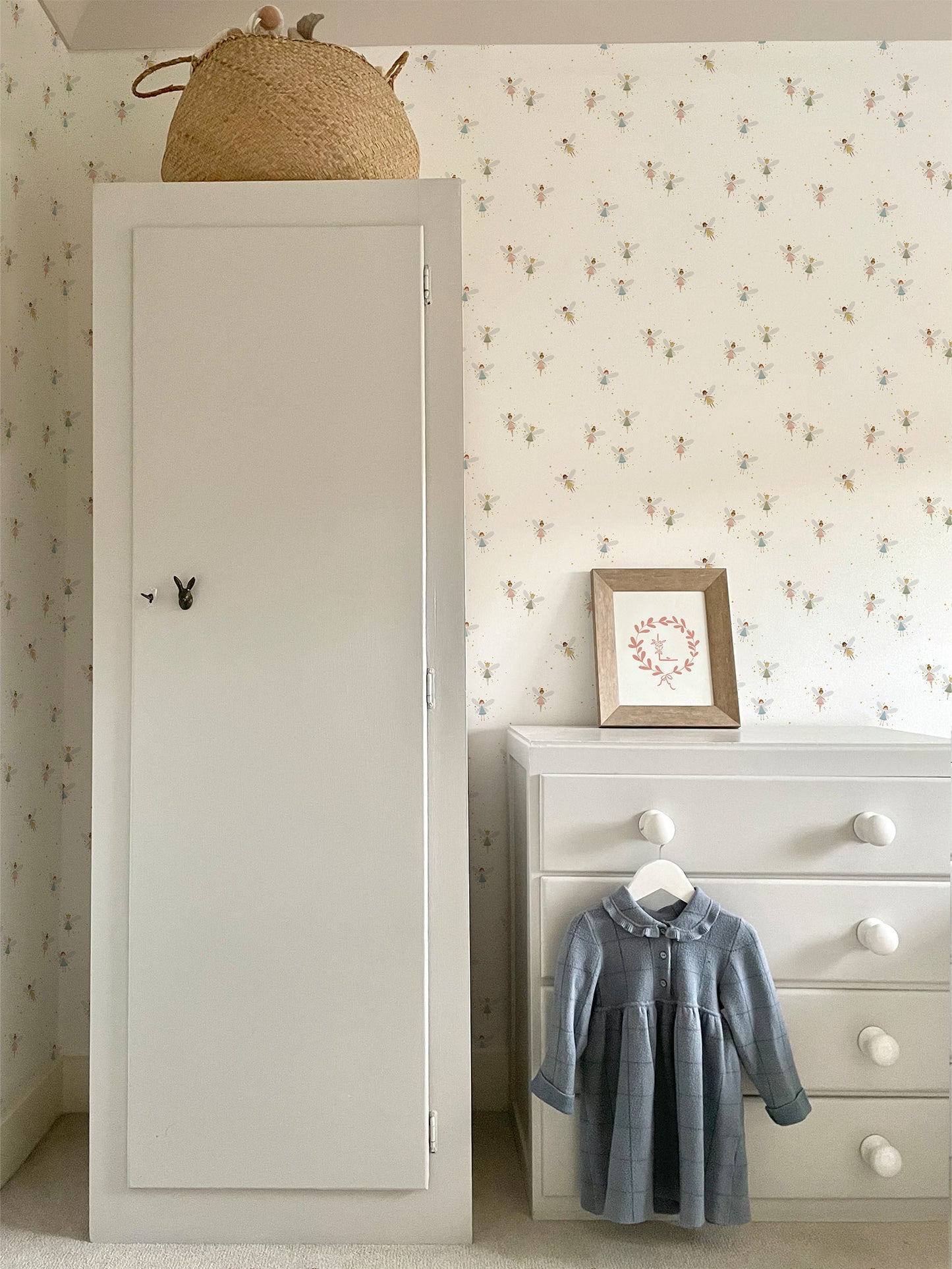 Girls bedroom with Fairy Dust luxury children's wallpaper, pale blue painted nursery furniture and blue girls dress